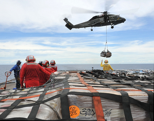 Helicopter moves supplies to USS Blue Ridge from USNS Rappahannock while enroute to Japan.