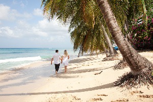Couple Strolling along beach in Caribbean