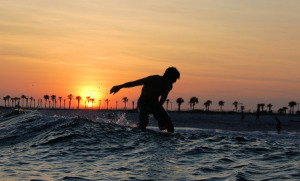 surfing at sunset